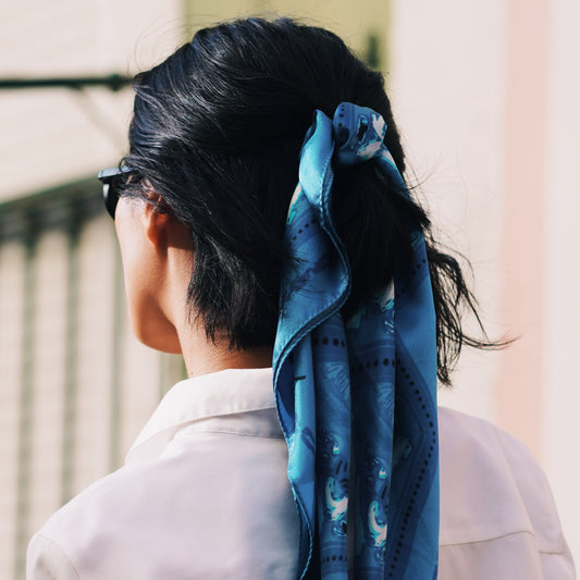 Senhora do Monte silk foulard worn in a ponytail in black hair