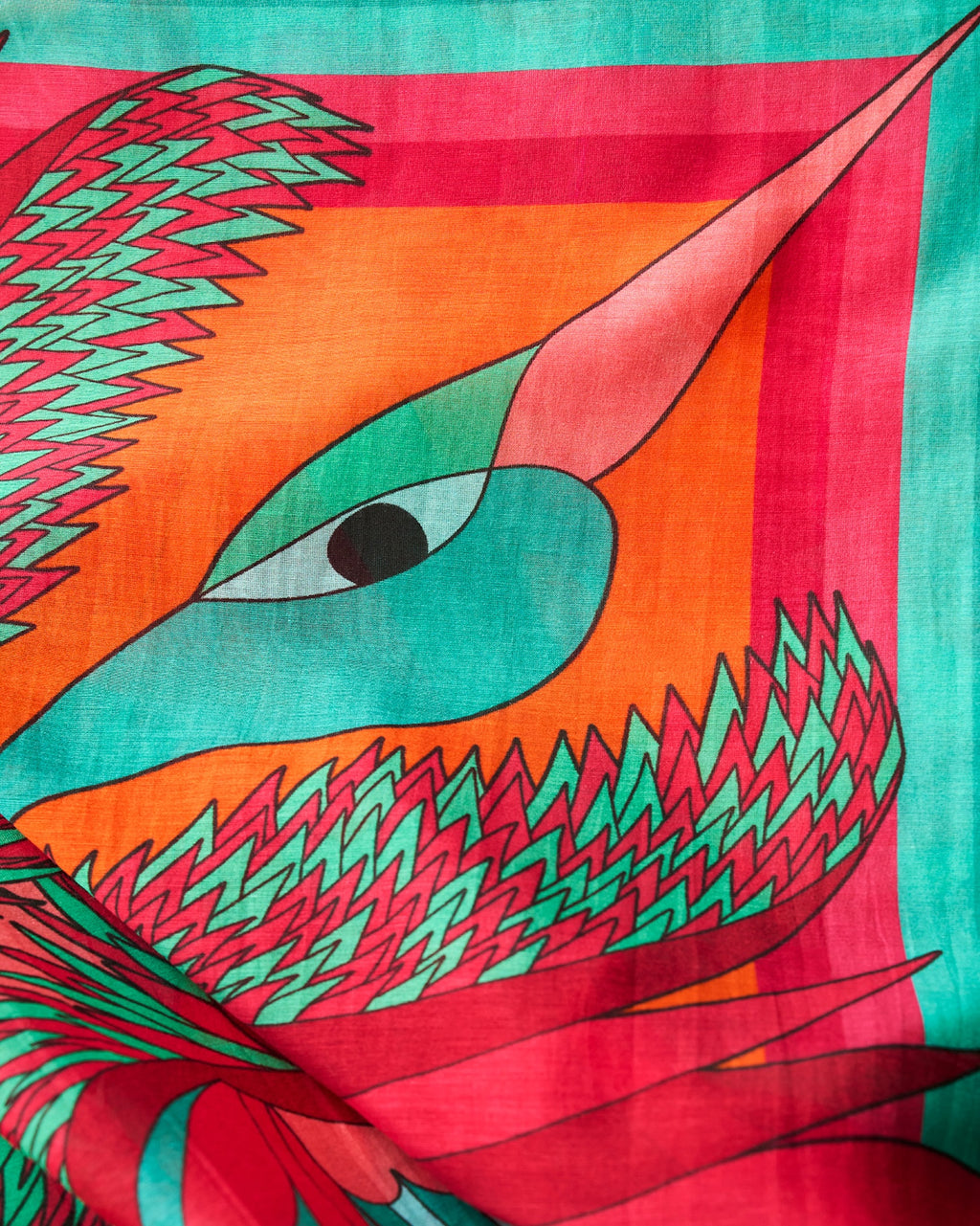 close up view of purple green pink orange silk cotton foulard named carnaval émeraude with decorative birds and bold colorful patterns