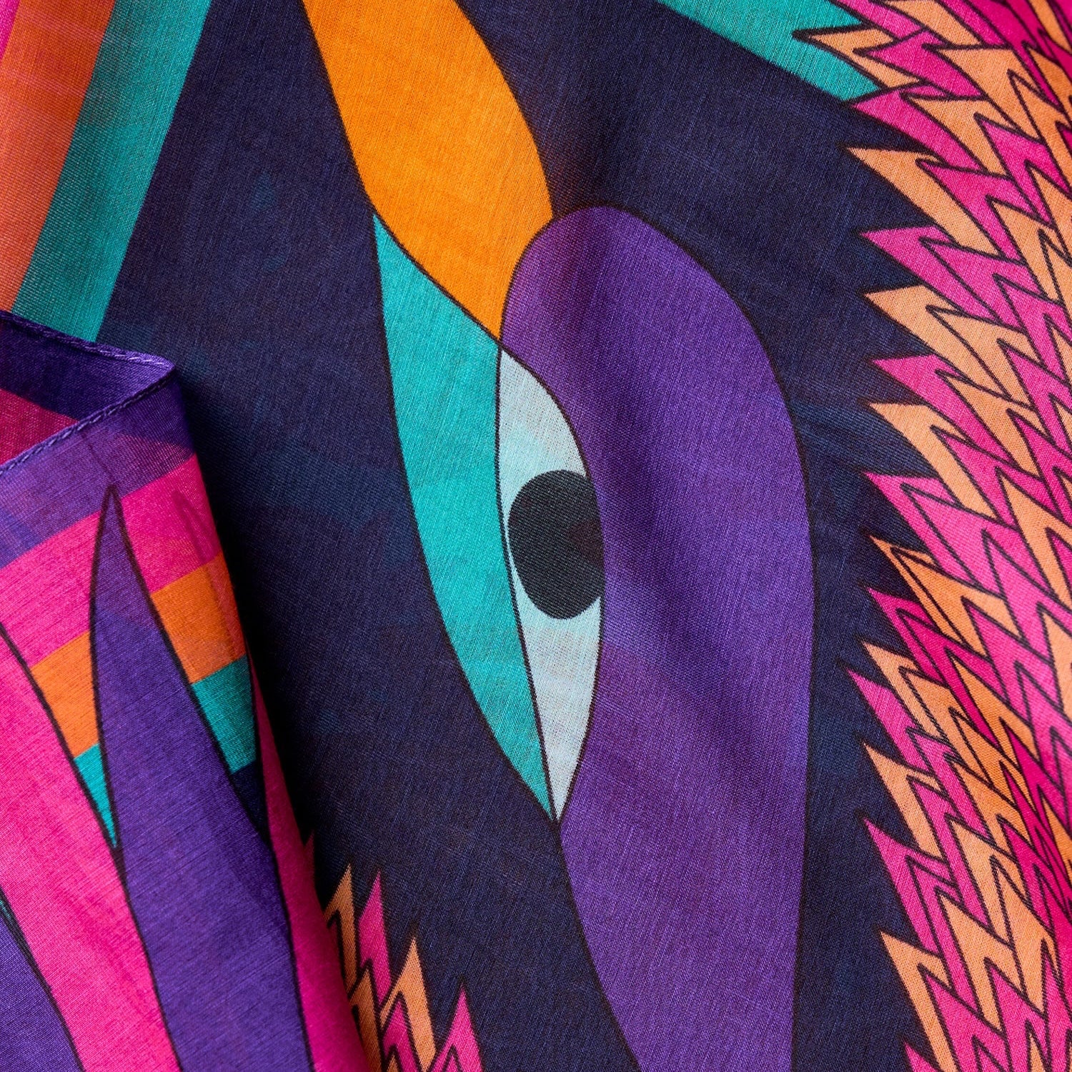 close up view of purple orange pink silk cotton foulard named carnaval nuit with decorative birds and bold colorful patterns
