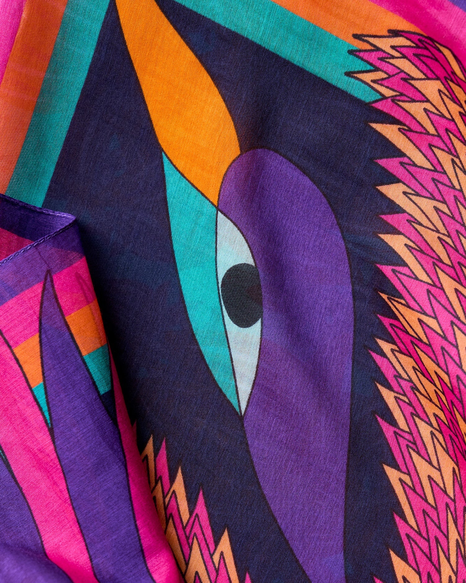 close up view of purple orange pink silk cotton foulard named carnaval nuit with decorative birds and bold colorful patterns